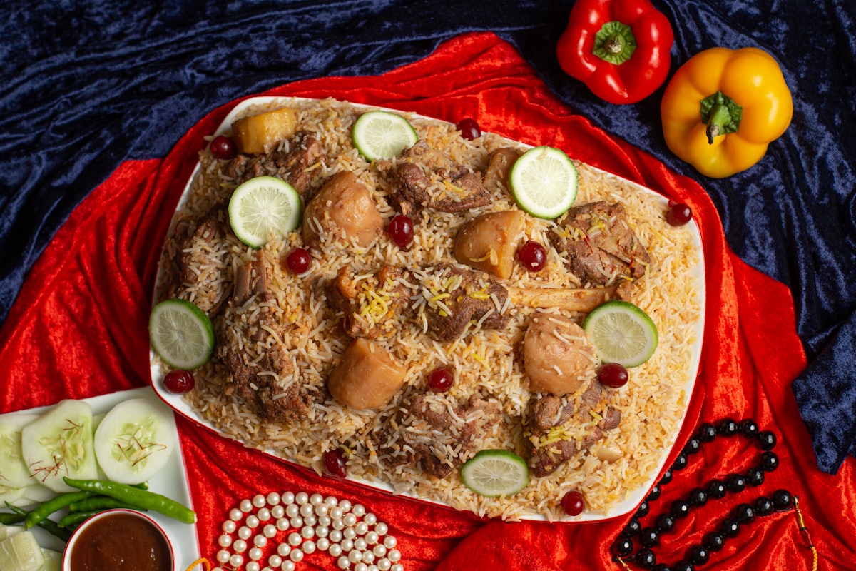 Festive biryani platter dressed with boiled eggs and lime on a red cloth